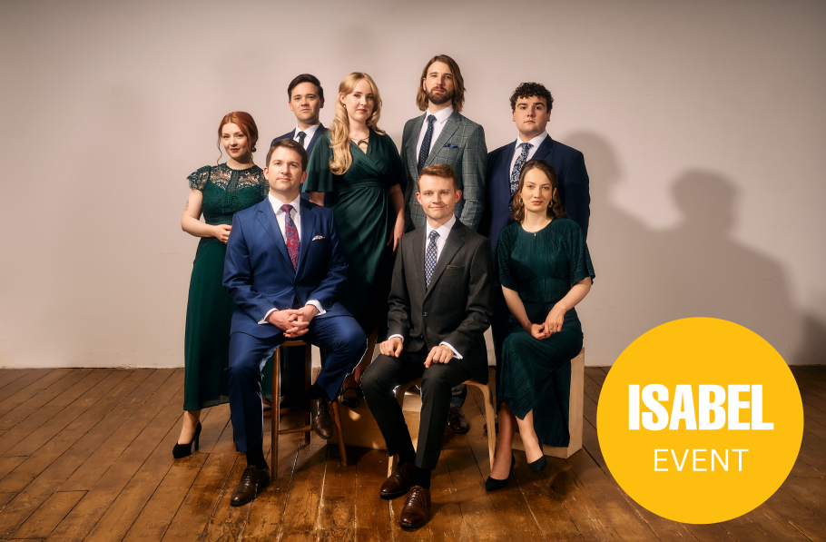 The 8 singers pose for the camera, all dressed in beautiful jewel-toned outfits