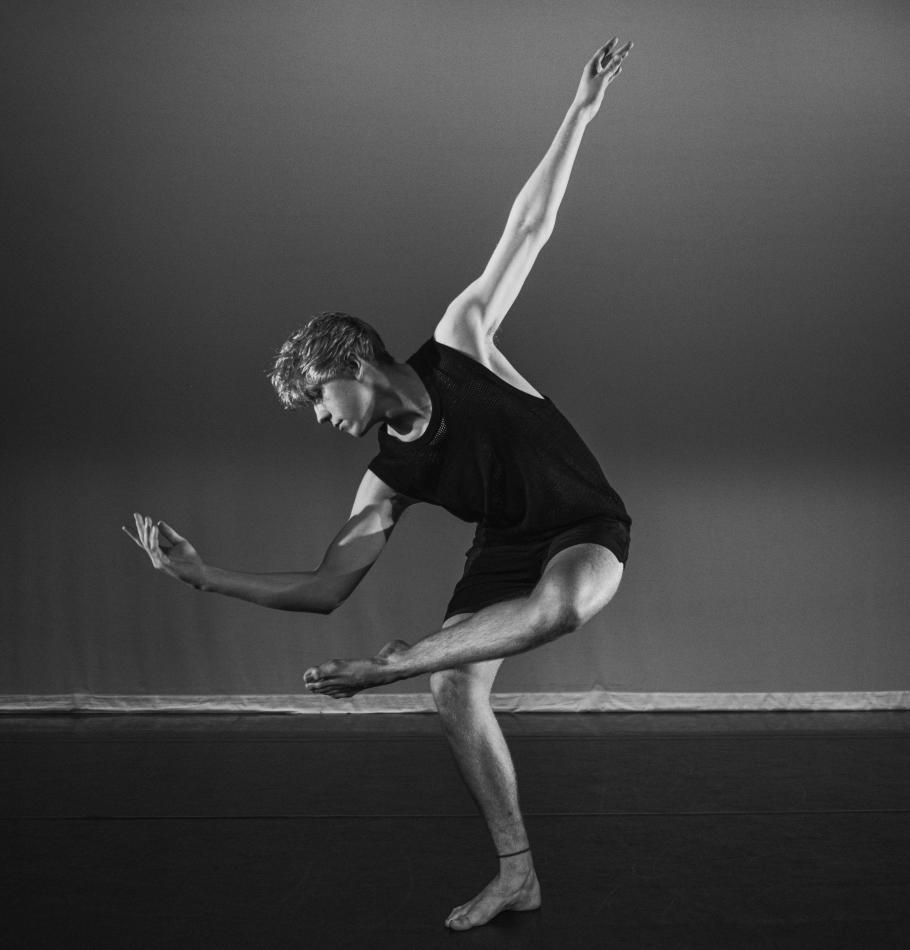 A dancer gracefully bends in a dynamic twist of limbs