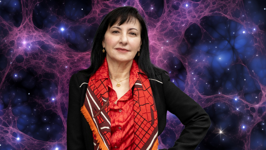 Prof Marcella Carena poses in front of a glittering galaxy