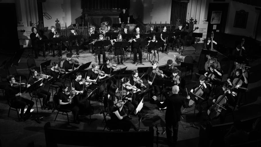 A moody black and white shot of the Kingston Youth Orchestra