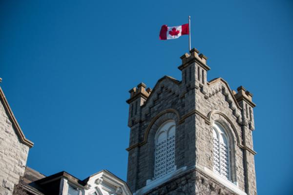 Queen's building with Canada flag on the roof