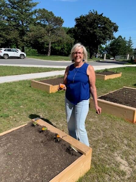 Team member by raised garden bed