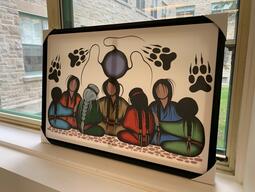 Indigenous artwork showing people sitting