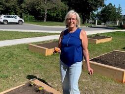 Team member by raised garden bed