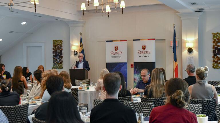 Principal Patrick Deane addresses the students and supervisors