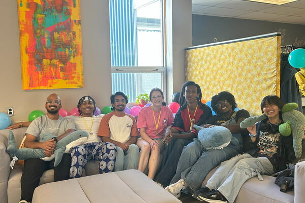 Group of happy students sitting on a couch.