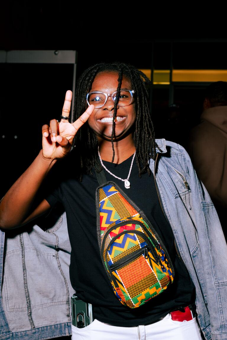 a person posing holding up a peace sign