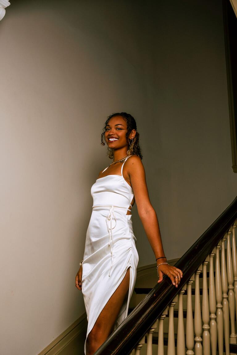 image of a person in a white dress posing on a staircase