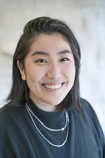 This is a headshot of Jane Mao from the shoulders up. They are looking at the camera smiling. 