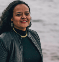 headshot of woman in black shirt